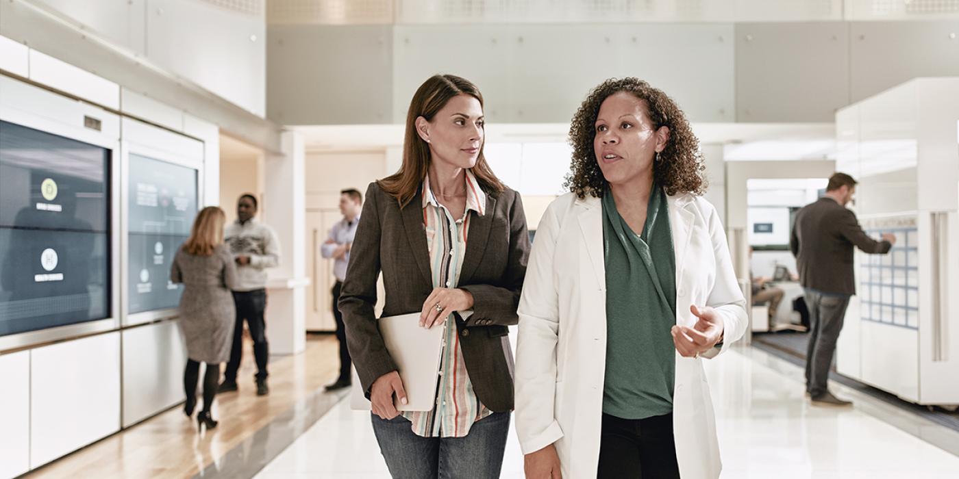 Client and pharmacist walking through the Evernorth Health Services Lab